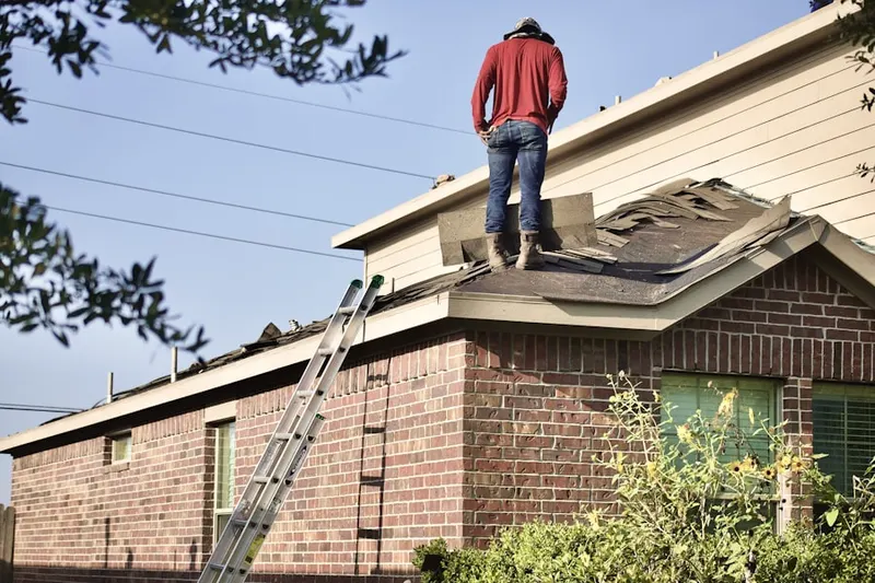 Professional roofer working on a residential roof in Succasunna